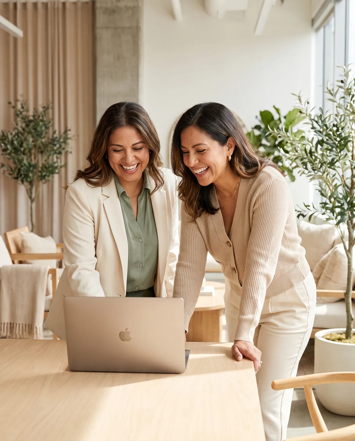 Two Altavia Staffing founders reviewing work together, smiling
